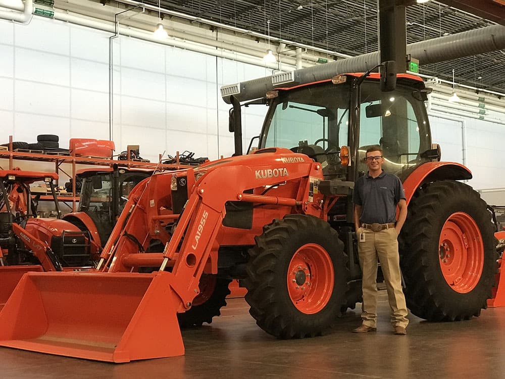 Brent in front of Kubota tractor