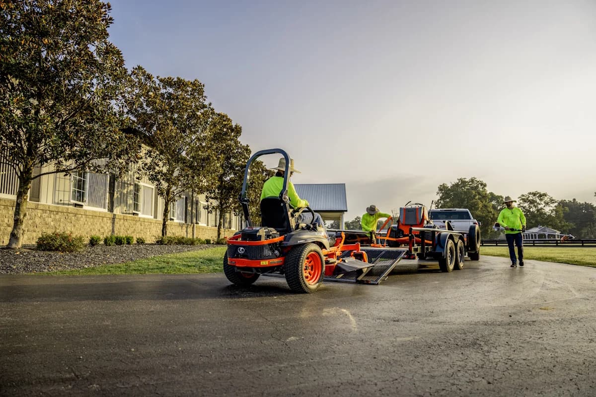 Mowers loading onto flatbed