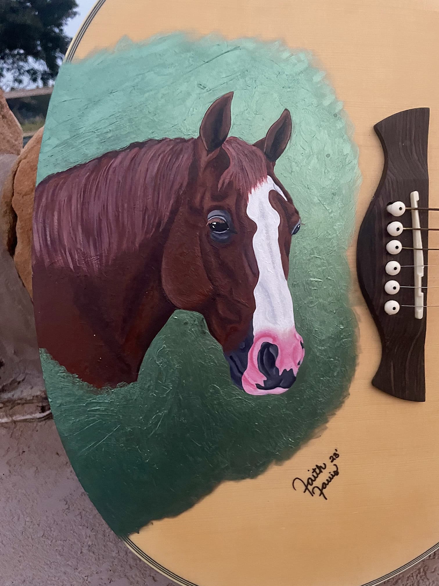 Close up of horse painted on guitar